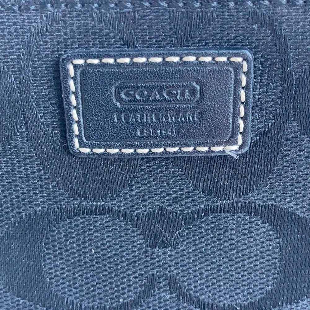 Coach black signature C mini wristlet.